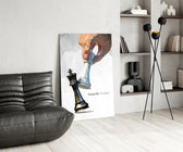 low-poly hand toppling a chess king glass wall art leaning beside a dark leather sofa