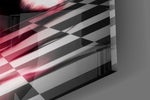 Close-up detail of the small black pawn lit red against the towering king silhouette on the glass surface