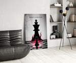 a pawn facing a king-sized shadow glass wall art leaning beside a dark leather sofa