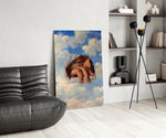 an eye and hand breaking through a painted sky glass wall art leaning beside a dark leather sofa