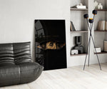 money talks torn dollar bill eyes glass wall art leaning beside a dark leather sofa