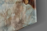 Close-up detail of the almost-touching fingertip and kitten paw over cracked fresco plaster on the glass surface