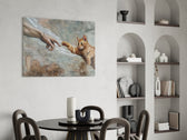 ginger kitten reaching a paw to a human hand glass wall art leaning beside a dark leather sofa