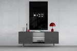 interlocking rich and risk typography glass wall art displayed above a console in a designer interior