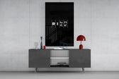 interlocking rich and risk typography glass wall art displayed above a console in a designer interior