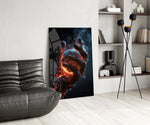 a molten stone hand cradling a glowing planet glass wall art leaning beside a dark leather sofa