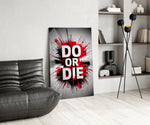do or die splatter typography glass wall art leaning beside a dark leather sofa