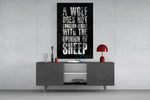 wolf opinion of sheep quote glass wall art displayed above a console in a designer interior
