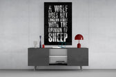 wolf opinion of sheep quote glass wall art displayed above a console in a designer interior