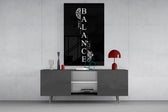 balance brain and heart quote glass wall art displayed above a console in a designer interior