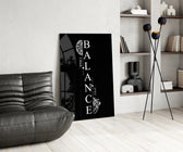 balance brain and heart quote glass wall art leaning beside a dark leather sofa