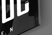 Close-up detail of the towering condensed capitals and the hidden hustle mottos woven through them on the glass surface