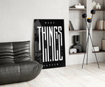 make things happen typography glass wall art leaning beside a dark leather sofa
