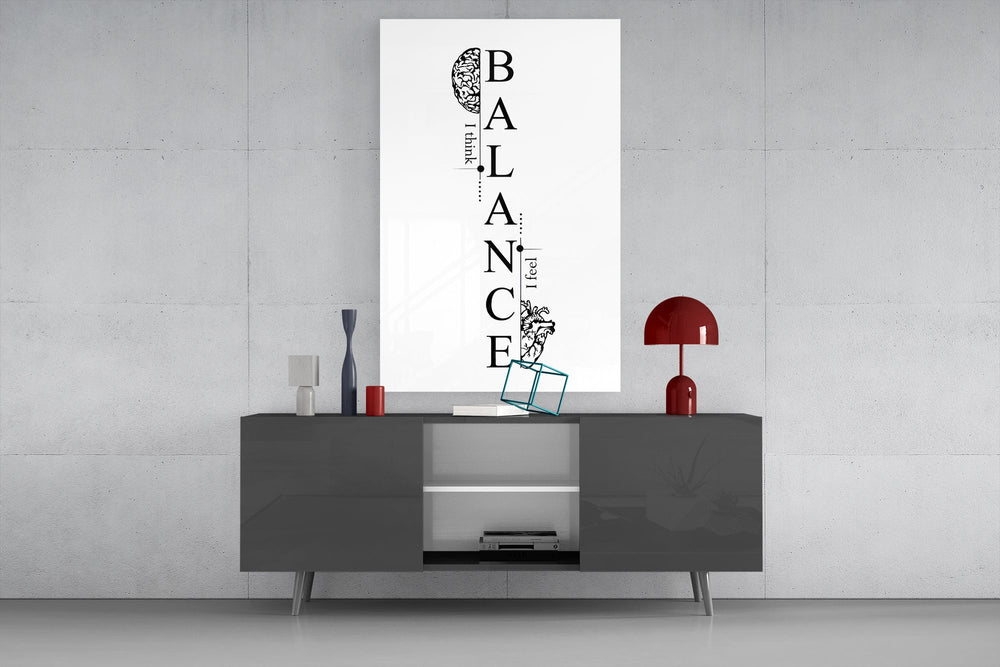 balance brain and heart typography glass wall art displayed above a console in a designer interior