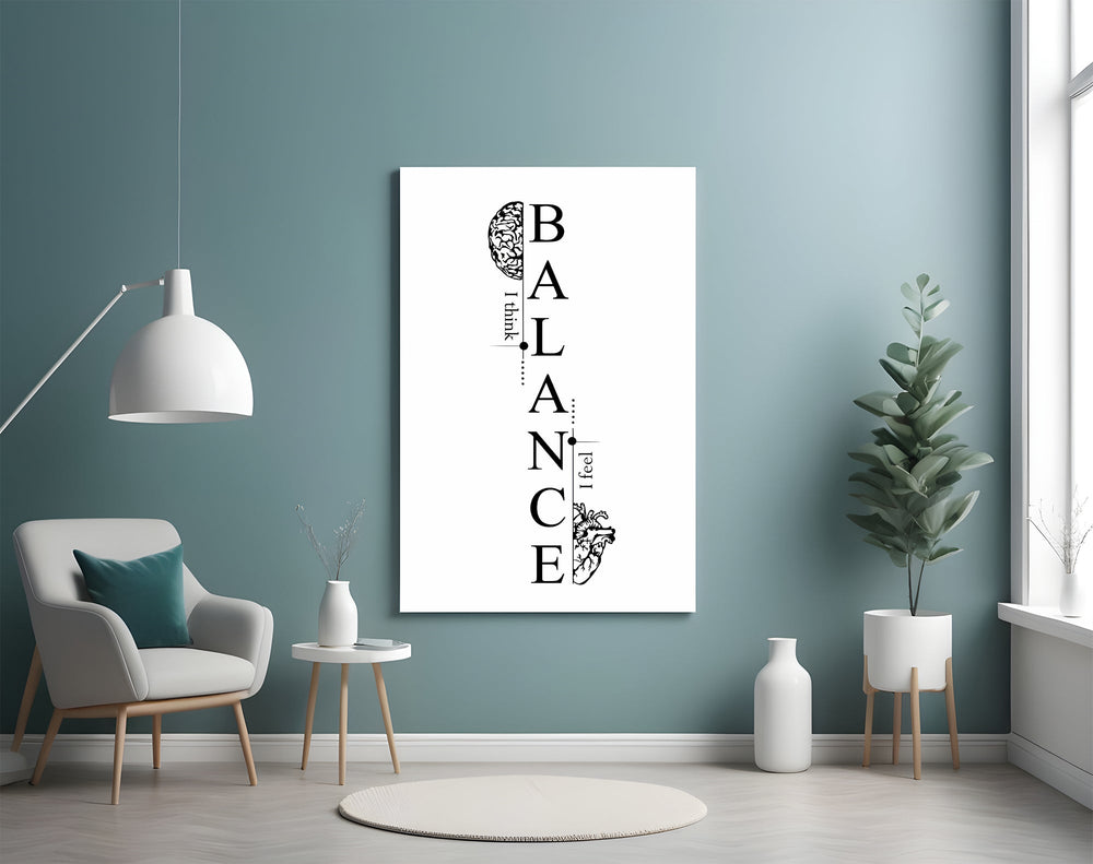 balance brain and heart typography glass wall art styled above an armchair in a reading corner