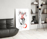 brain unravelling into red threads glass wall art leaning beside a dark leather sofa