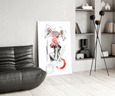 brain unravelling into red threads glass wall art leaning beside a dark leather sofa