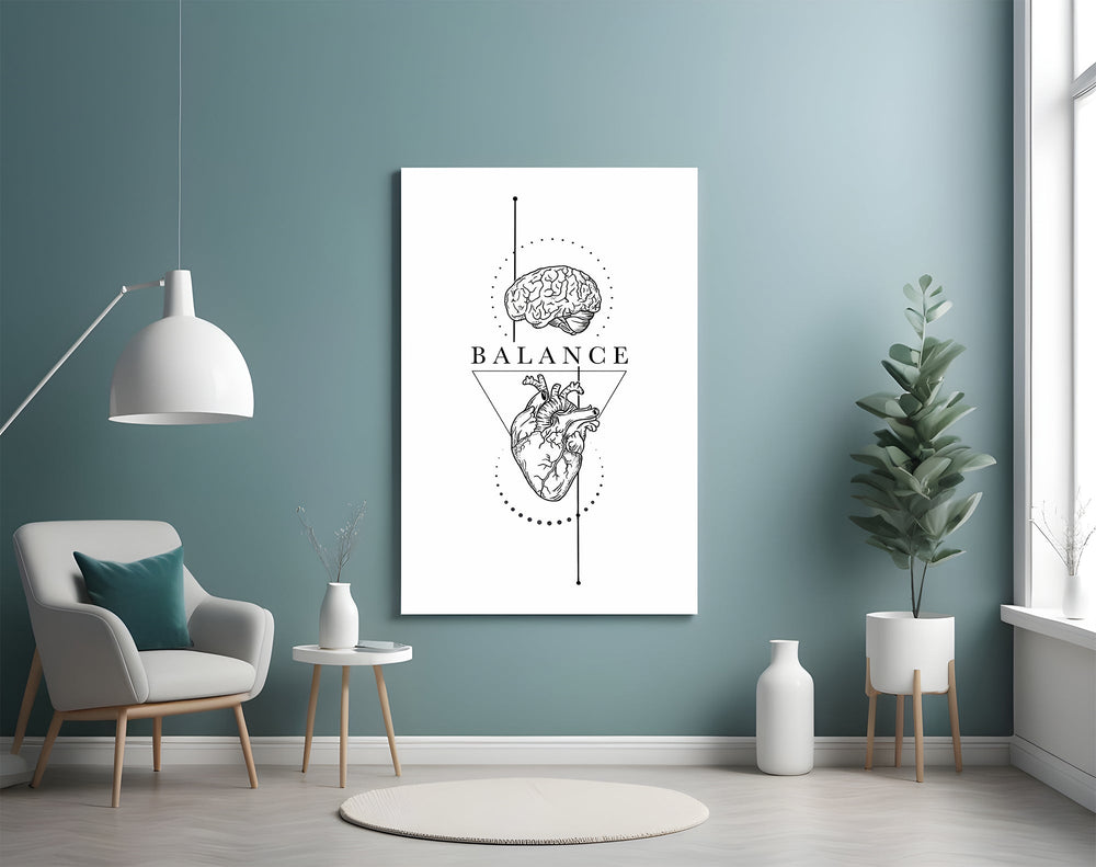 brain above heart balance line art glass wall art styled above an armchair in a reading corner