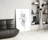 brain above heart balance line art glass wall art leaning beside a dark leather sofa