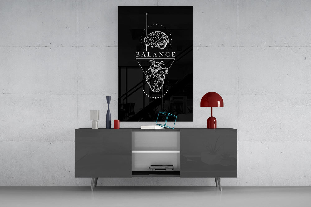 brain above heart balance on black glass wall art displayed above a console in a designer interior