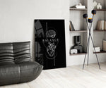 brain above heart balance on black glass wall art leaning beside a dark leather sofa