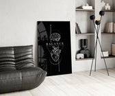 brain above heart balance on black glass wall art leaning beside a dark leather sofa