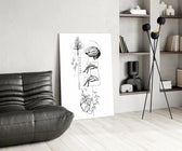 surreal balance collage of brain and heart glass wall art leaning beside a dark leather sofa