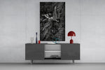 winged figure every fall to rise glass wall art displayed above a console in a designer interior
