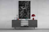 winged figure every fall to rise glass wall art displayed above a console in a designer interior