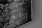 Close-up detail of the feathered wings and classical marble figure against dark smoke on the glass surface