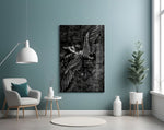 winged figure every fall to rise glass wall art styled above an armchair in a reading corner
