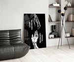 memento mori vivere reaching hands glass wall art leaning beside a dark leather sofa