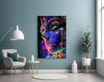 neon dot psychedelic woman's face glass wall art styled above an armchair in a reading corner