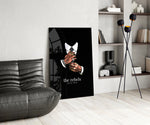 tattooed hands and the words the rebels never obey glass wall art leaning beside a dark leather sofa
