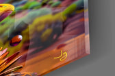 Close-up detail of the amber bubbles and dripping paint across the cheek on the glass surface