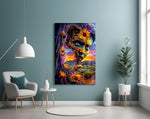 a painted face opening onto a desert sunset glass wall art styled above an armchair in a reading corner