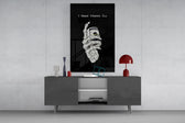 a skeleton hand gripping a roll of cash glass wall art displayed above a console in a designer interior