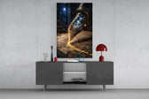 a fountain pen nib holding a cosmic amphitheatre glass wall art displayed above a console in a designer interior