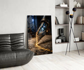 a fountain pen nib holding a cosmic amphitheatre glass wall art leaning beside a dark leather sofa