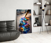 a fountain pen writing a glowing world glass wall art leaning beside a dark leather sofa