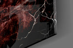 Close-up detail of the glowing red fissures behind the chrome letters on the glass surface