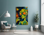green alien smoking in deep space glass wall art styled above an armchair in a reading corner