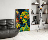 green alien smoking in deep space glass wall art leaning beside a dark leather sofa