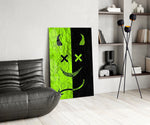 split neon green devil smiley glass wall art leaning beside a dark leather sofa