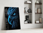 glowing blue eagle head on black panel resting in a shelving niche in a modern interior