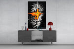 orange lava rift and lone figure glass wall art displayed above a console in a designer interior