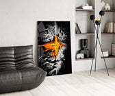 orange lava rift and lone figure glass wall art leaning beside a dark leather sofa