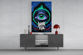 green flame eye over a night coastline glass wall art displayed above a console in a designer interior