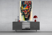layered faces around a screaming skull glass wall art displayed above a console in a designer interior