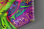Close-up detail of the violet almond eyes and the patterned hands cupping the jaw on the glass surface